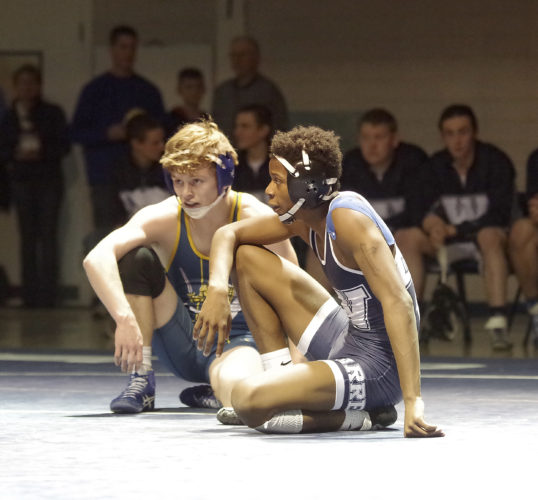 Times Observer photo by Ben Oviatt Eisenhower's Sam Holt and Warren's Alex Weston listen to instructions from the referee prior to overtime in the 132-pound bout.